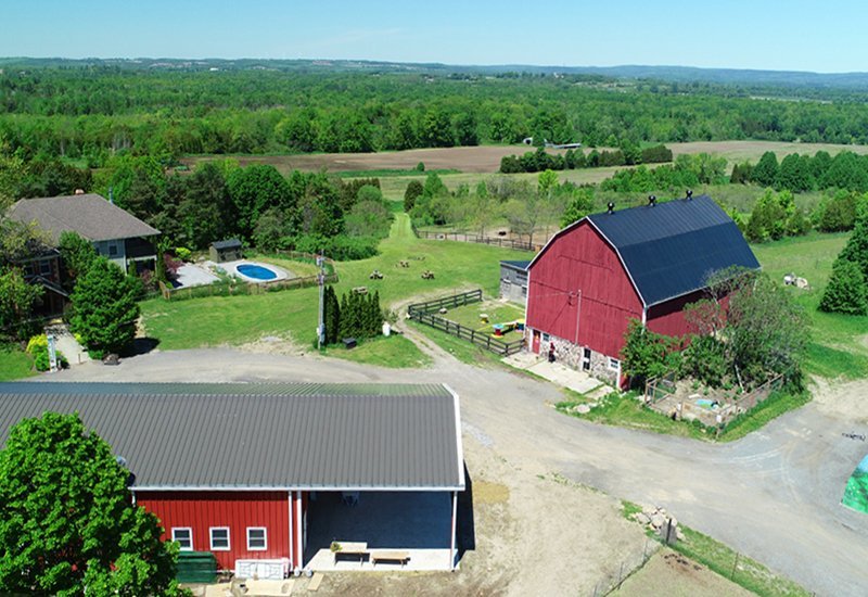 Custom designed prefab steel agricultural building with overhang porch and residential area