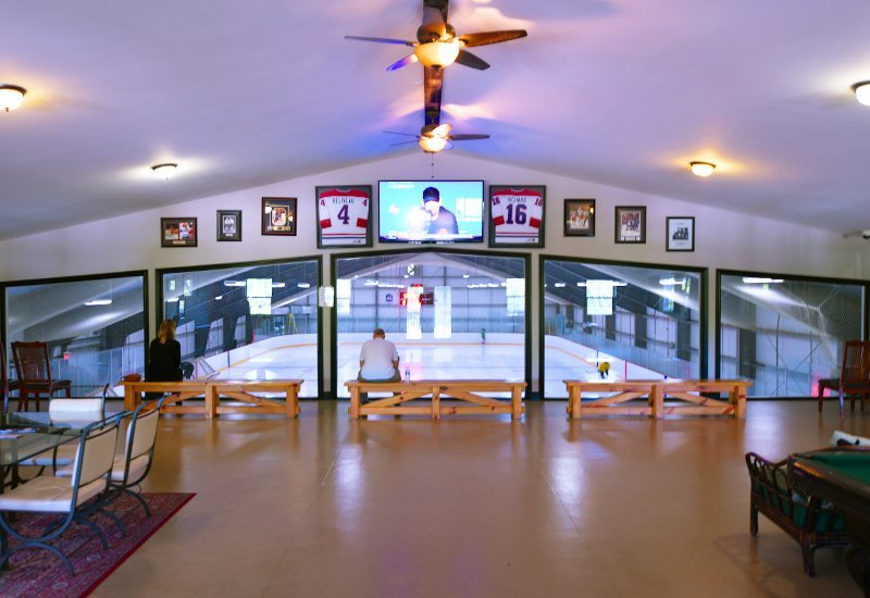 Interior image of a prefab steel hockey arena viewing from upper floor steel mezzanine