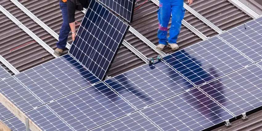 Solar panels being installed on a steel roof